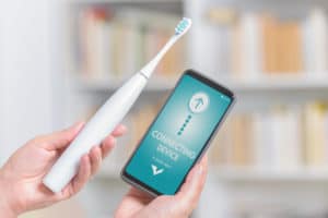 wireless connecting sonic toothbrush with smart phone app. Modern home technology concept