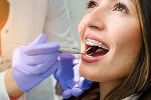 woman getting braces examined