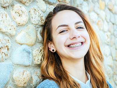 young adult girl with braces smiling