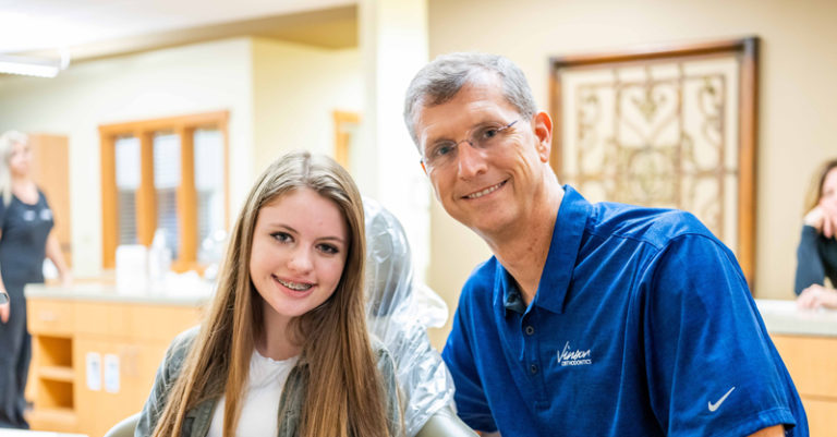 Girl with braces with Doctor from Vinson Orthodontics