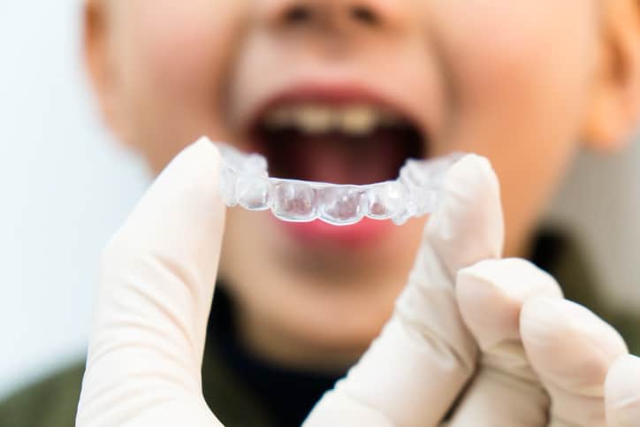 Child receiving early orthodontic treatment in Clayton, NC getting Invisalign from his orthodontist